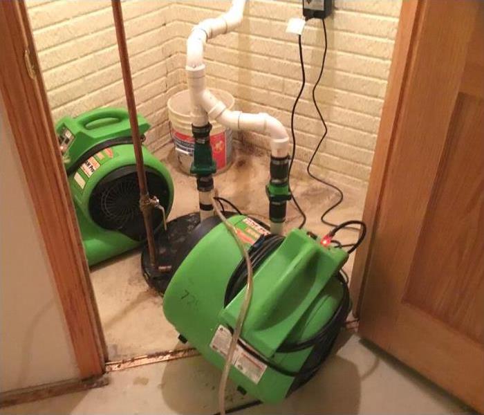 Air movers placed and drying the water from the area.