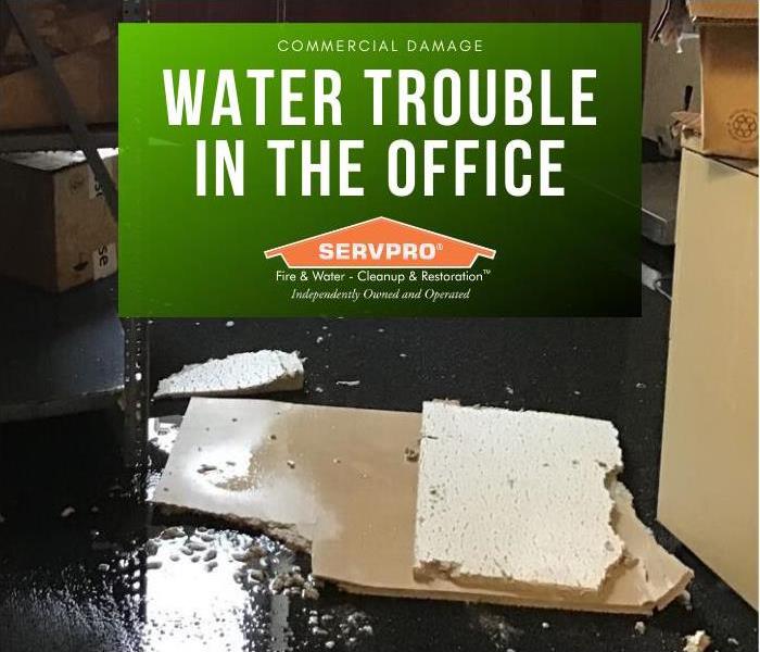 Soaked ceiling tiles on wet office floor. Water damage in office building.