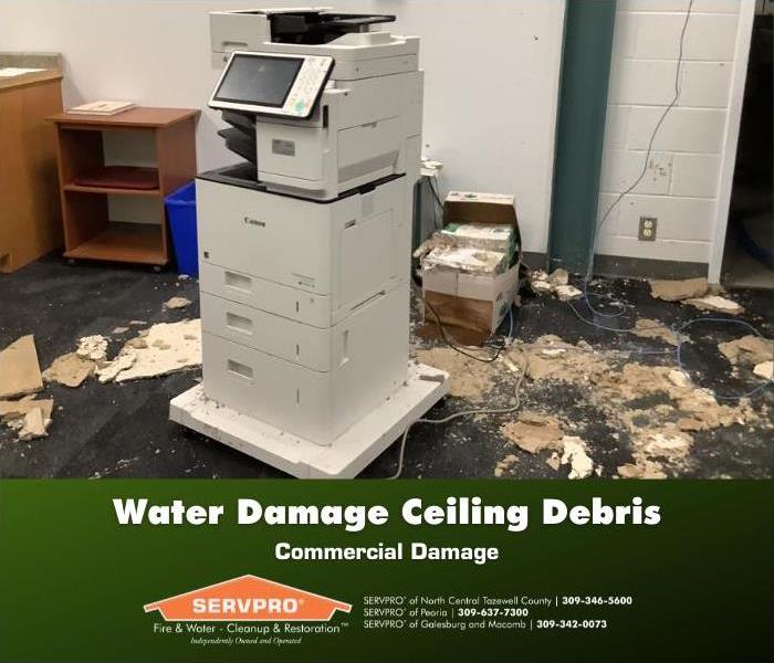 Commercial break room with water damage and debris damage all over the floor.