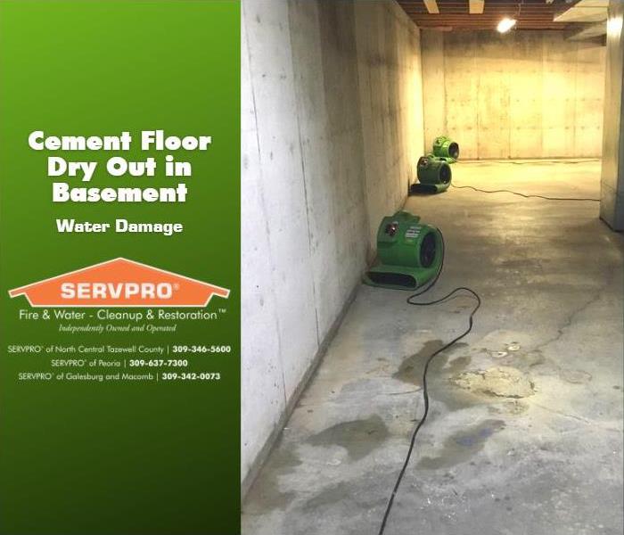 Equipment place for drying cement floor in a large residential basement.