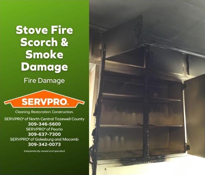 Cupboard scorched and smoke damaged after stove fire.